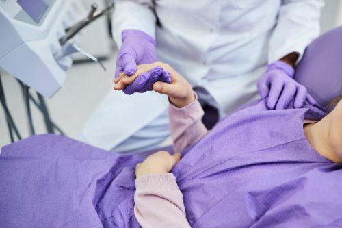 patient holding dentists hand