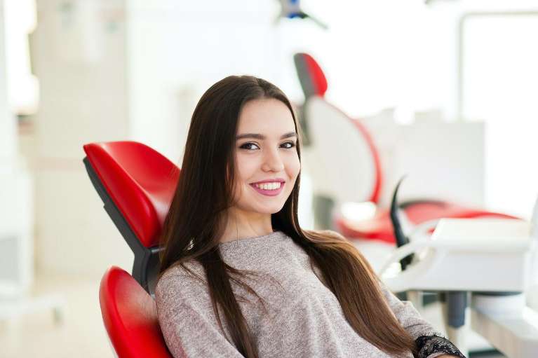 woman sitting in a red chair